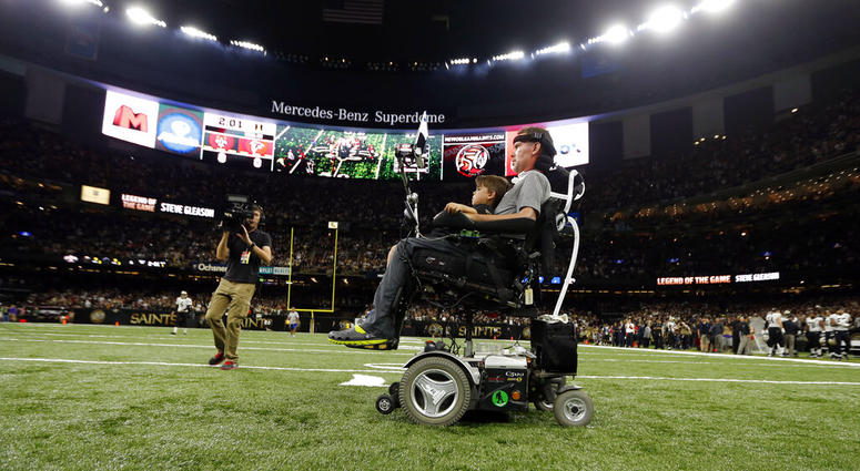 former New Orleans Saints player Steve Gleason rides onto the field with with his son Rivers before an NFL football game against the Atlanta Falcons in New Orleans former New Orleans Saints player Steve Gleason rides onto the field with with his son Rivers before an NFL football game against the Atlanta Falcons in New Orleans