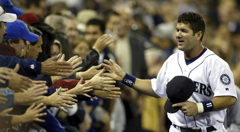 Seattle Mariners Edgar Martinez high fiving Mariner fans as he runs the track surrounding the infield during Edgar Martinez Day in Seattle AP DO NOT USE