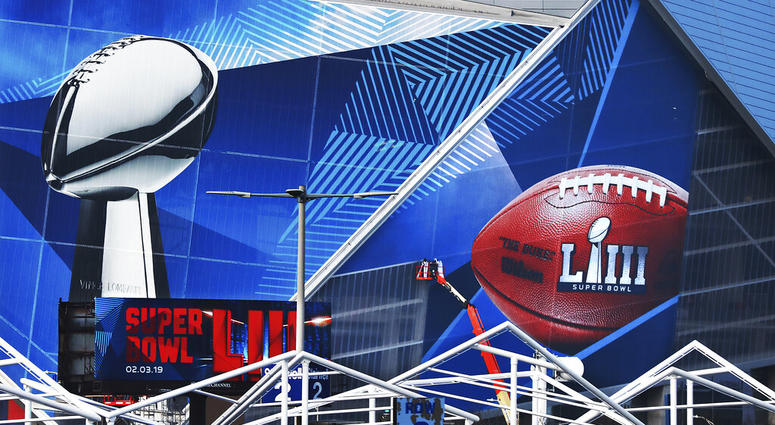 workers use a lift to install a Super Bowl 53 wrap on the outside of Mercedes-Benz Stadium as it is transformed for the big NFL football game in Atlanta AP DO NOT USE