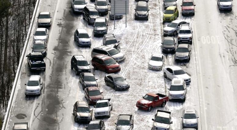 aerial file photo, abandoned cars at I-75 headed northbound near the Chattahoochee River overpass are piled up in the median of the ice-covered interstate after a winter snow storm, in Atlanta AP DO NOT USE