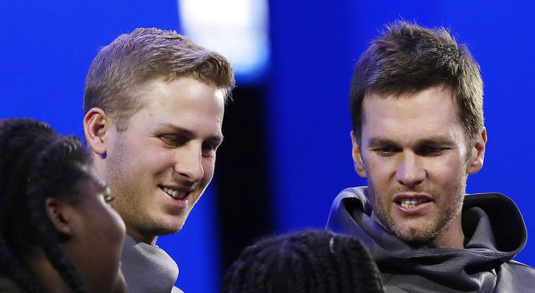Los Angeles Rams' Jared Goff and New England Patriots' Tom Brady speaks with children during Opening Night for the NFL Super Bowl 53 football game Monday, AP DO NOT USE