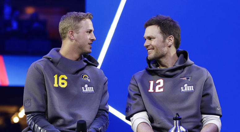 Los Angeles Rams' Jared Goff talks to New England Patriots' Tom Brady during Opening Night for the NFL Super Bowl 53 football game Monday, AP DO NOT USE