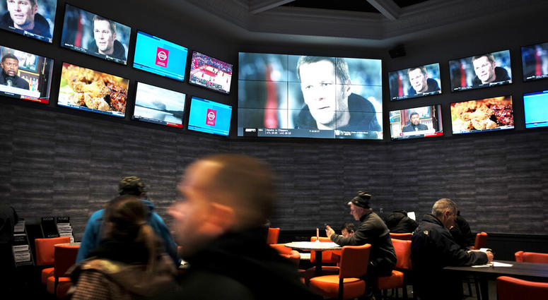 patrons visit the sports betting area of Twin River Casino in Lincoln, R.I. AP DO NOT USE