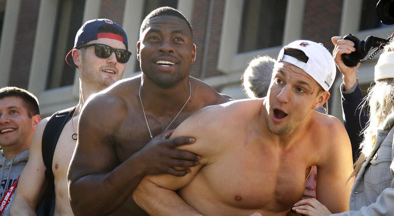 ew England Patriots tight ends Dwayne Allen, left, and Rob Gronkowski react to fans during the team's parade DO NOT USE