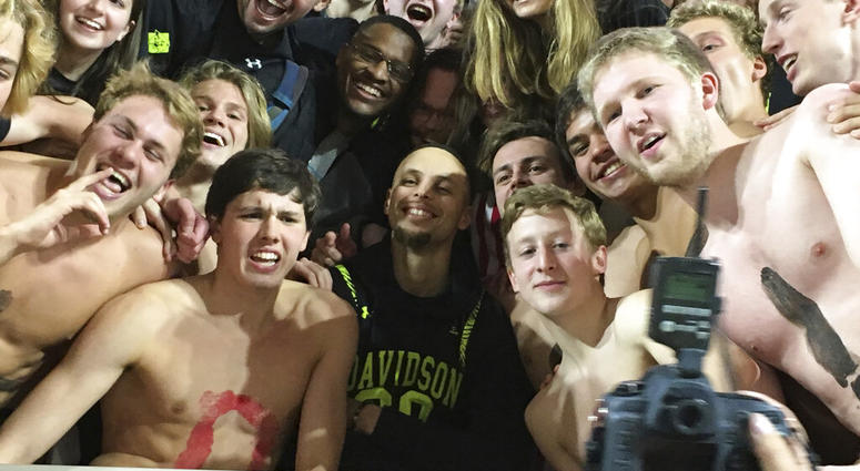 Golden State Warriors' Stephen Curry, center, poses with the Davidson College swim team as he takes in an NCAA college basketball game at his alma mater Friday, Feb. 15, 2019, while back in his hometown of Charlotte, N.C., for the NBA basketball All-Star Golden State Warriors' Stephen Curry, center, poses with the Davidson College swim team as he takes in an NCAA college basketball game at his alma mater Friday, Feb. 15, 2019, while back in his hometown of Charlotte, N.C., for the NBA basketball All-Star