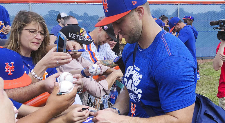 New York Mets' Tim Tebow signs autographs at spring training baseball practice Saturday, Feb. 16, 2019, in Port St. Lucie, Fla New York Mets' Tim Tebow signs autographs at spring training baseball practice Saturday, Feb. 16, 2019, in Port St. Lucie, Fla