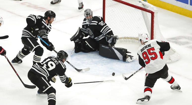 Ottawa Senators center Matt Duchene (95) is defended by Chicago Blackhawks Jonathan Toews (19), Duncan Keith (2) and goaltender Cam Ward (30) AP DO NOT USE