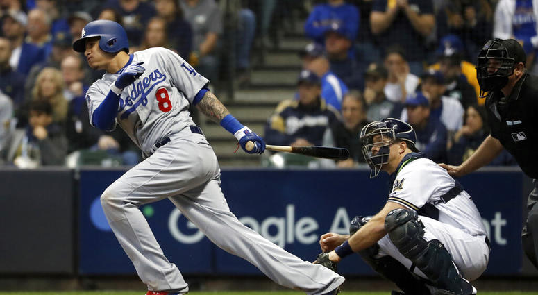 then-Los Angeles Dodgers' Manny Machado (8) hits a single during the fourth inning of Game 7 of the National League Championship Series baseball game against the Milwaukee Brewers, in Milwaukee. AP DO NOT USE