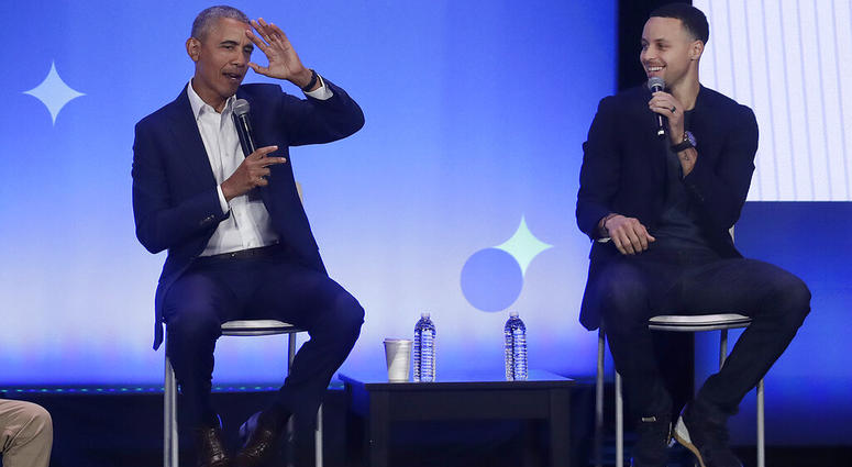 Former President Barack Obama, left, gestures as Golden State Warriors basketball player Stephen Curry laughs while speaking at the My Brother's Keeper Alliance Summit in Oakland, Calif., Tuesday, Feb. 19, 2019. DO NOT USE