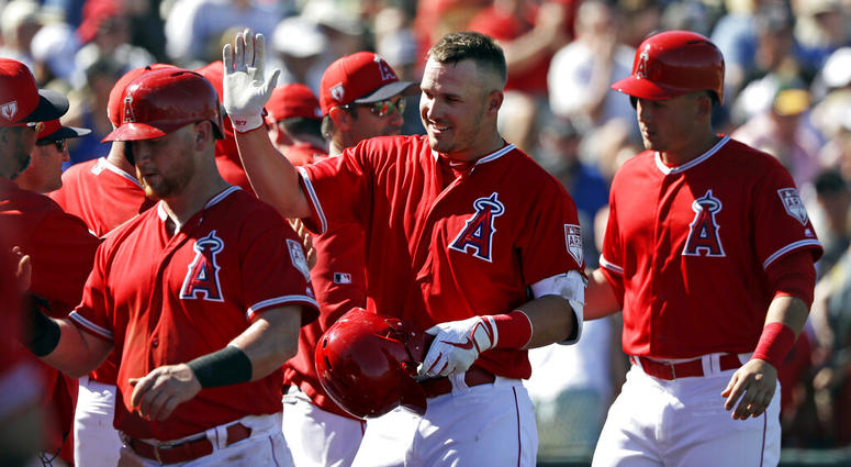 Los Angeles Angels' Mike Trout, center, is congratulated on his three-run home run against the Chicago Cubs in the third inning of a spring training baseball game Tuesday, March 5, 2019, in Tempe, Ariz. AP DO NOT USE