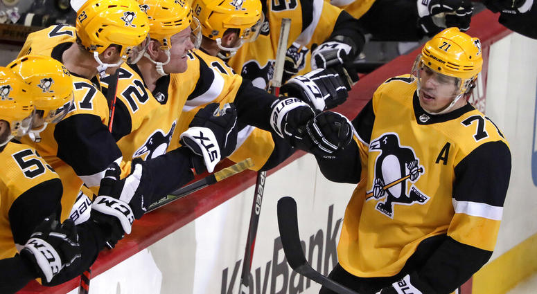 Pittsburgh Penguins' Evgeni Malkin (71) celebrates with teammates after assisting on a goal by Phil Kessel, for the 1,000th point of his NHL career AP DO NOT USE