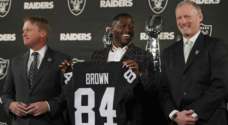 Oakland Raiders wide receiver Antonio Brown, center, holds his jersey beside coach Jon Gruden, left, and general manager Mike Mayock during an NFL football news conference Wednesday, March 13, 2019, in Alameda, Calif. ( Oakland Raiders wide receiver Antonio Brown, center, holds his jersey beside coach Jon Gruden, left, and general manager Mike Mayock during an NFL football news conference Wednesday, March 13, 2019, in Alameda, Calif. (