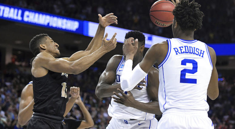 Central Florida guard Aubrey Dawkins, left, battles for a rebound against Duke's Zion Williamson, and Cam Reddish (5) after missing a potential game-winning tip-in during the second half of a second-round game AP DO NOT USE