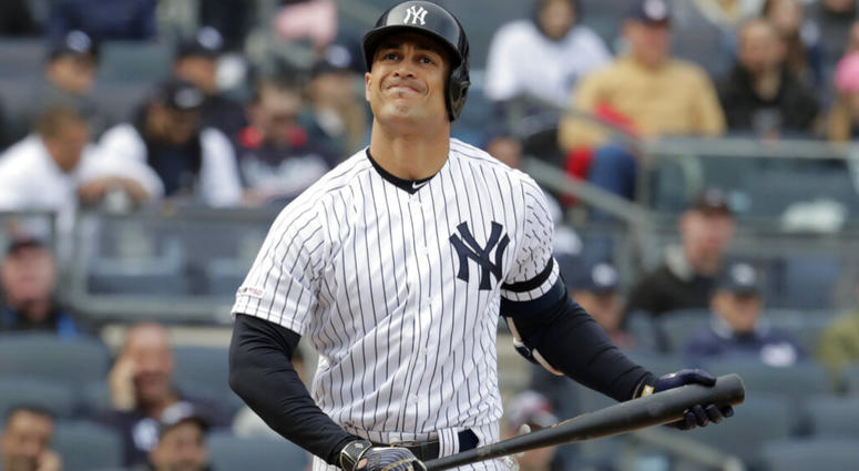 New York Yankees' Giancarlo Stanton reacts after striking out to Baltimore Orioles relief pitcher Paul Fry during the eighth inning of an opening day baseball game at Yankee Stadium, Thursday, March 28, 2019, in New York. AP DO NO TUSE