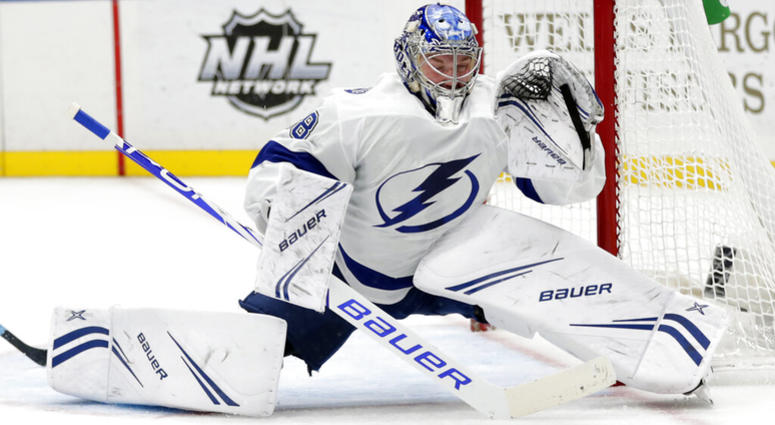 This March 23, 2019, file photo shows Tampa Bay Lightning goaltender Andrei Vasilevskiy (88) deflecting a shot with his glove in the second period of an NHL hockey game against the St. Louis Blues, in St. Louis. AP DO NOT USE