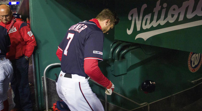 Washington Nationals' Trea Turner heads to the clubhouse after a pitch hit his hand while batting during the first inning of a baseball game against the Philadelphia Phillies at Nationals Park, Tuesday, April 2, 2019, in Washington. AP DO NOT USE