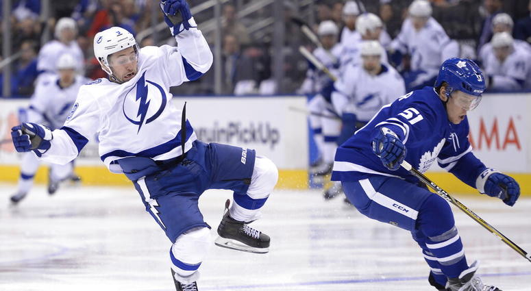 Toronto Maple Leafs defenseman Jake Gardiner (51) checks Tampa Bay Lightning centre Tyler Johnson (9) during third period NHL hockey action in Toronto on Thursday, April 4, 2019. AP DO NOT USE