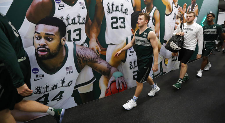 Michigan State guard Jack Hoiberg walks to the court for a practice session for the semifinals of the Final Four NCAA college basketball tournament, Friday, April 5, 2019, in Minneapolis AP DO NOT USE
