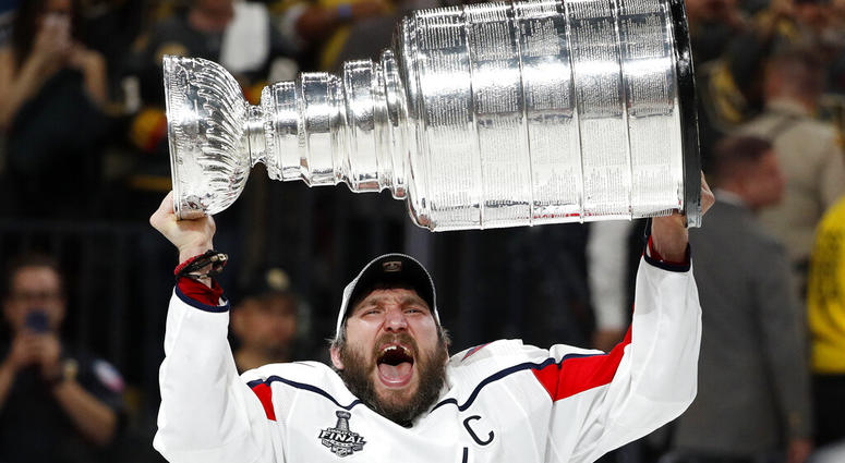 In this June 7, 2018, file photo, Washington Capitals left wing Alex Ovechkin, of Russia, hoists the Stanley Cup AP DO NOT USE
