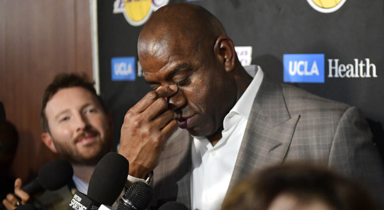 Magic Johnson wipes his eyes as he speaks to reporters prior to an NBA basketball game between the Los Angeles Lakers and the Portland Trail Blazers on Tuesday, April 9, 2019, in Los Angeles. AP DO NOT USE
