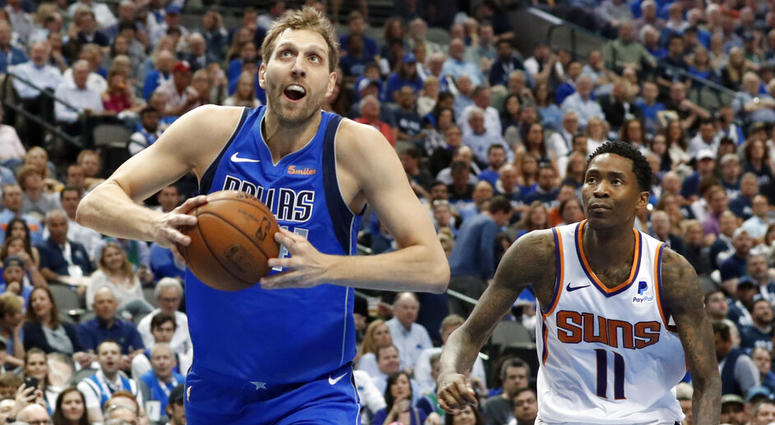 Dallas Mavericks forward Dirk Nowitzki (41) drives past Phoenix Suns guard Jamal Crawford (11) to the basket for a dunk during the second half of an NBA basketball game in Dallas, Tuesday, April 9, 2019. AP DO NOT USE