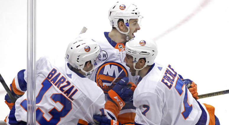 New York Islanders' Jordan Eberle (7) celebrates with Adam Pelech, center, and Mathew Barzal (13) after scoring against the Pittsburg Penguins during the first period in Game 4 of an NHL first-round hockey playoff series in Pittsburgh, Tuesday, April 16, AP DO NOT USE