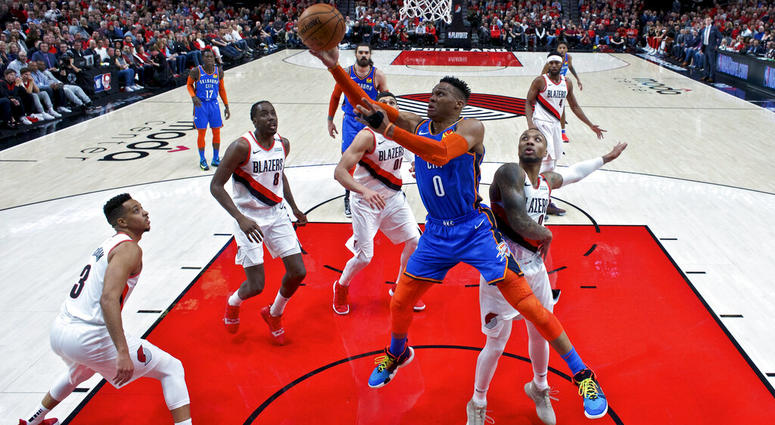 Oklahoma City Thunder guard Russell Westbrook, center, shoots over Portland Trail Blazers guard Damian Lillard, right, during the first half of Game 2 of an NBA basketball first-round playoff series Tuesday, April 16, 2019, in Portland, Ore. AP DO NOT USE