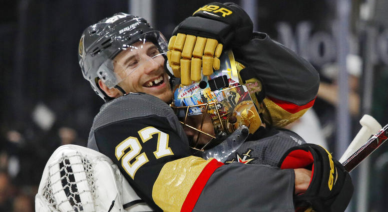 Vegas Golden Knights defenseman Shea Theodore, left, embraces goaltender Marc-Andre Fleury after the team's win over the San Jose Sharks in Game 4 of a first-round NHL hockey playoff series Tuesday, April 16, 2019, in Las Vegas. AP DO NOT USE