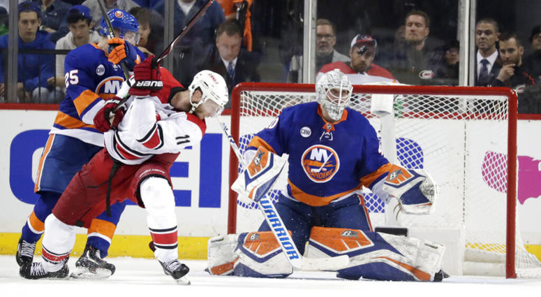 New York Islanders goaltender Robin Lehner, of Sweden, eyes the puck as teammate defenseman Devon Toews (25) blocks Carolina Hurricanes center Jordan Staal (11) during the second period of Game 1 of an NHL hockey second-round playoff series, Friday, April AP DO NOT USE