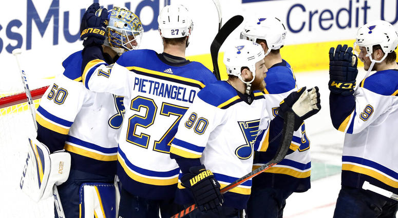 St. Louis Blues goaltender Jordan Binnington (50) celebrates with Alex Pietrangelo (27), Ryan O'Reilly (90), David Perron, center rear, and Sammy Blais (9), following the team's 4-1 win against the Dallas Stars in Game 6 of an NHL second-round hockey play AP DO NOT USE