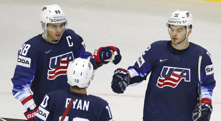 Alex Debrincat of the US, right, celebrates with teammates Patrick Kane, left, and Derek Ryan, center, after scoring his sides fourth goal during the Ice Hockey World Championships group A match between the United States and Great Britain AP DO NOT USE
