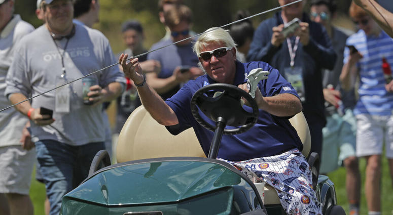 John Daly lifts a rope to get his golf cart to the 12th tee during the first round of the PGA Championship golf tournament, Thursday, May 16, 2019, at Bethpage Black in Farmingdale, N.Y. AP DO NOT USE