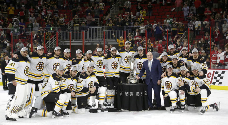 Boston Bruins players pose with the Prince of Wales trophy and Bill Daly, deputy commissioner of the National Hockey League, following Game 4 of the NHL hockey Stanley Cup Eastern Conference finals against the Carolina Hurricanes in Raleigh, N.C., Thursda AP DO NOT USE