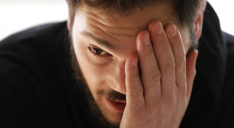 In this Tuesday, April 2, 2019, photo, former NHL player Dan Carcillo rubs his forehead during an interview with The Associated Press at his rural home in Homer Glen, Ill. AP DO NO TUSE