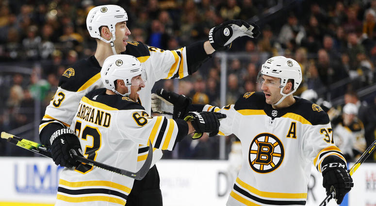, Boston Bruins' Brad Marchand, front, celebrates with teammates Zdenoa Chara, back left, and Patrice Bergeron , Boston Bruins' Brad Marchand, front, celebrates with teammates Zdenoa Chara, back left, and Patrice Bergeron