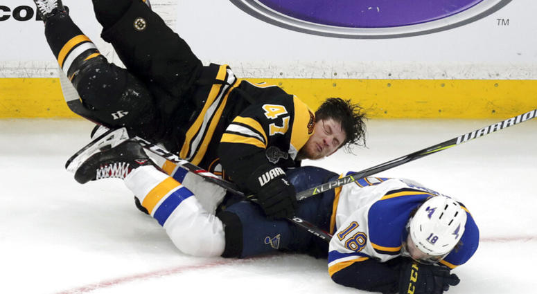 Boston Bruins' Torey Krug (47) and St. Louis Blues' Robert Thomas (18) crash to the ice during the third period in Game 1 of the NHL hockey Stanley Cup Final, Monday, May 27, 2019, in Boston. AP DO NOT USE