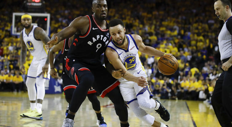 Golden State Warriors guard Stephen Curry (30) dribbles against Toronto Raptors center Serge Ibaka (9) during the second half of Game 3 of basketball's NBA Finals in Oakland, Calif AP DO NOT USE