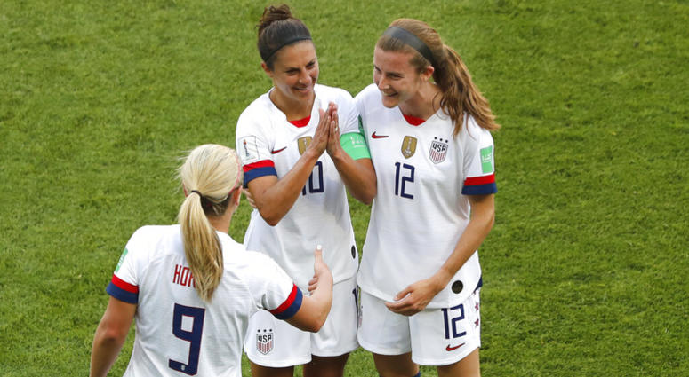 United States' Carli Lloyd , center, celebrates with Lindsey Horan and Tierna Davidson, right, after scoring the opening goal during the Women's World Cup Group F soccer match between the United States and Chile at the Parc des Princes in Paris, Sunday, J AP DO NOT USE