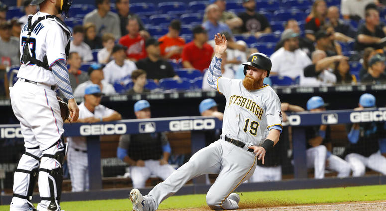 Pittsburgh Pirates' Colin Moran (19) slides into home as Miami Marlins catcher Bryan Holaday looks on during the fourth inning of a baseball game, Sunday, June 16, 2019, in Miami. Moran scored on a double by Jung Ho Kang. Pittsburgh Pirates' Colin Moran (19) slides into home as Miami Marlins catcher Bryan Holaday looks on during the fourth inning of a baseball game, Sunday, June 16, 2019, in Miami. Moran scored on a double by Jung Ho Kang.