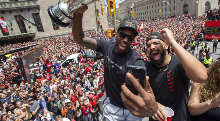 Toronto Raptors' Kawhi Leonard holds his MVP trophy while celebrating with rapper/producer Drake during the team's NBA basketball championship parade in Toronto, Monday, June 17, 2019. AP DO NO TUSE