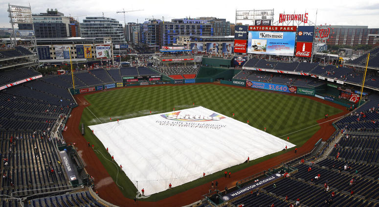 A tarp covers the infield during a rain delay before a baseball game between the Philadelphia Phillies and the Washington Nationals, Monday, June 17, 2019, in Washington.