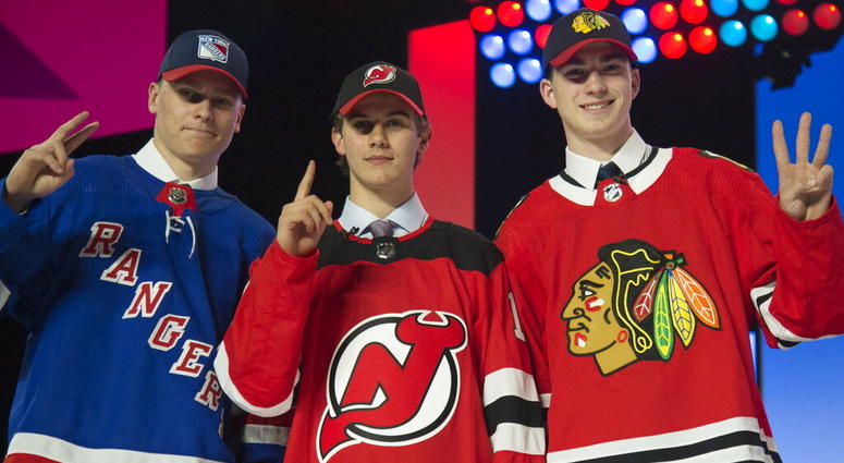New York Rangers draft pick Kaapo Kakko, left; New Jersey Devils pick Jack Hughes, center; and Chicago Blackhawks pick Kirby Dach pose for photos during the first round of the NHL hockey draft New York Rangers draft pick Kaapo Kakko, left; New Jersey Devils pick Jack Hughes, center; and Chicago Blackhawks pick Kirby Dach pose for photos during the first round of the NHL hockey draft