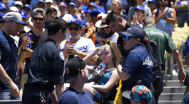 A young fan is carted away after being hit with a foul ball hit by Los Angeles Dodgers' Cody Bellinger during the first inning of a baseball game against the Colorado Rockies, Sunday, June 23, 2019, in Los Angeles. A young fan is carted away after being hit with a foul ball hit by Los Angeles Dodgers' Cody Bellinger during the first inning of a baseball game against the Colorado Rockies, Sunday, June 23, 2019, in Los Angeles.