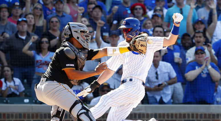 Chicago Cubs' Kris Bryant, right, scores against Pittsburgh Pirates' Jacob Stallings, left, during the eighth inning of a baseball game, Friday, July 12, 2019, in Chicago. Chicago Cubs' Kris Bryant, right, scores against Pittsburgh Pirates' Jacob Stallings, left, during the eighth inning of a baseball game, Friday, July 12, 2019, in Chicago.