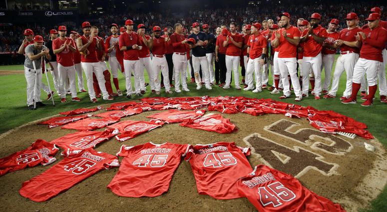 Members of the Los Angeles Angels place their jerseys with No. 45 in honor of pitcher Tyler Skaggs AP DO NOT USE