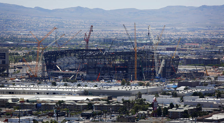 In this June 4, 2019, file photo, construction cranes surround the football stadium under construction in Las Vegas.