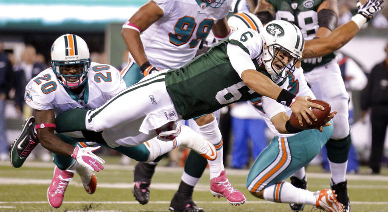 In this Oct. 17, 2011, file photo, New York Jets quarterback Mark Sanchez (6) dives away from Miami Dolphins free safety Reshad Jones (20) for a touchdown during the second quarter of an NFL football game, in East Rutherford, N.J. AP DO NOT USE