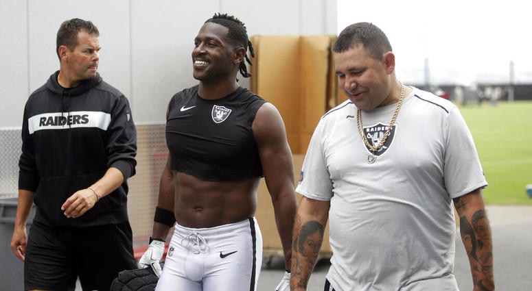 Oakland Raiders' Antonio Brown, center, walks off the field after NFL football practice in Alameda, Calif., Tuesday, Aug. 20, 2019.