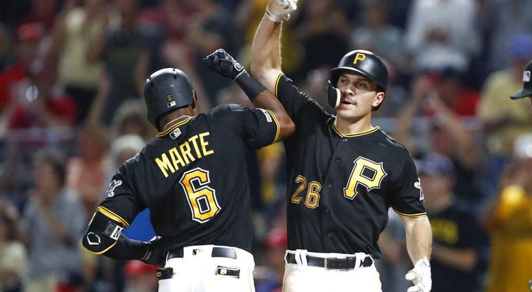 Pittsburgh Pirates' Starling Marte (6) celebrates with Adam Frazier after hitting a three-run home run in the eighth inning of a baseball game, Tuesday, Aug. 20, 2019, in Pittsburgh. AP DO NOT USE