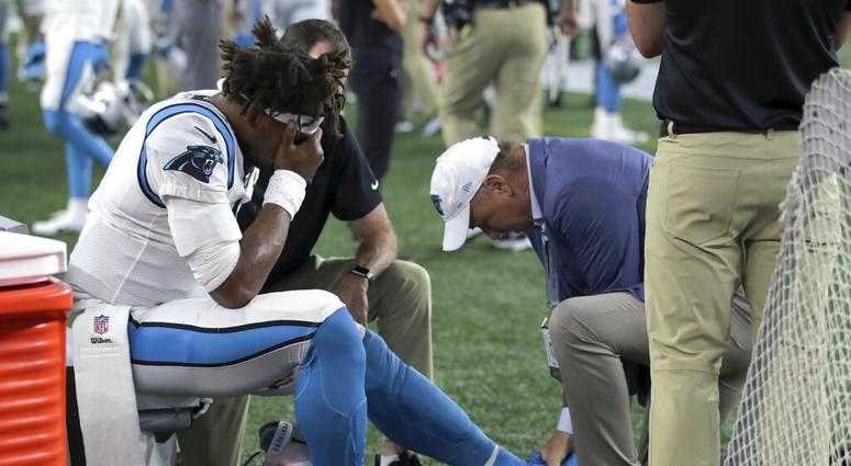 Carolina Panthers quarterback Cam Newton (1) receives attention on the sideline after an injury Carolina Panthers quarterback Cam Newton (1) receives attention on the sideline after an injury